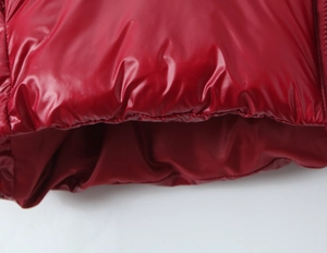 Detailed macro shot of glossy red puffer jacket fabric with high-quality stitching