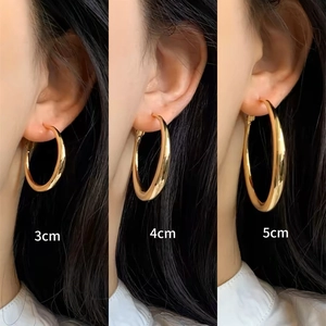 Comparison of 3cm, 4cm, and 5cm thick gold hoop earrings worn on model for size scaling