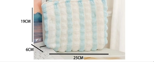 Detail view of the blue and white striped puffy cosmetic bag showing dimensions 25x19x6cm