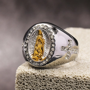 Macro detail of men's religious ring with Virgin Mary relief and rhinestone cross