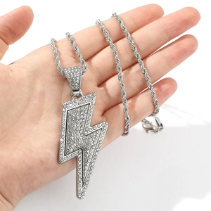 Detailed view of silver lightning bolt pendant with sparkling crystals on rope chain