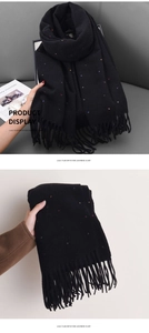 Detail of black imitation cashmere scarf with colorful polka dots and fringe tassels