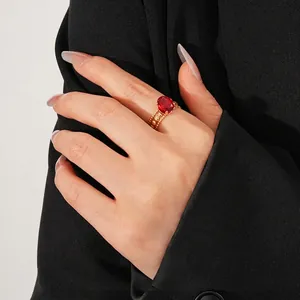 Vintage gold-plated ring with oval red gemstone and textured bead band on a model hand