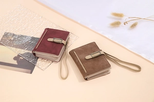 Detail view of burgundy and brown vintage faux suede wallets with antique bronze buckles