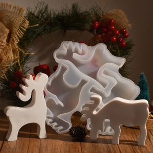 Macro shot of 3D reindeer silicone mold with finished white resin deer on festive table