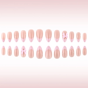 Pink French press-on nails with 3D bows and pearls in various sizes for a romantic look