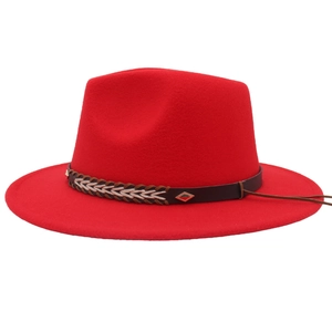 Detailed macro of the red wool fedora hat with a black leather band and metal buckle