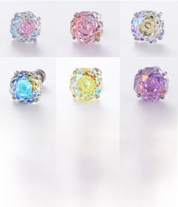 Macro detail of screw-back octagon zirconia earrings in polished titanium steel