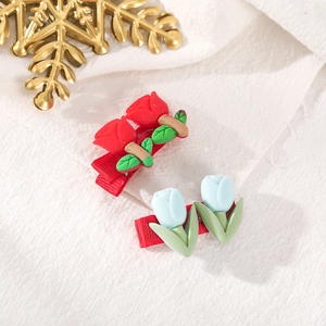 Set of 2 Christmas hair clips with red rose and blue tulip floral designs on red ribbon base