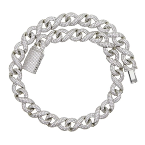 Detailed macro shot of a silver iced-out cuban link necklace with a secure box clasp