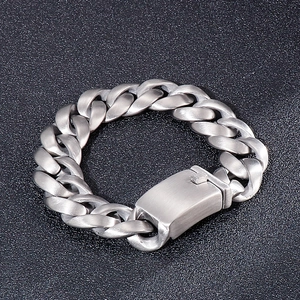 Detail of brushed silver titanium steel Cuban link bracelet with matte industrial texture