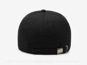 Rear view of black corduroy baseball cap showing adjustable metal buckle and ribbed texture