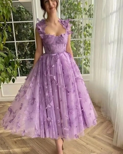Close-up of lightweight tulle wedding dress featuring 3D butterfly floral appliques