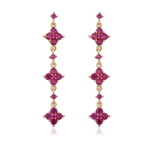 Detailed view of long gold geometric earrings with vibrant rose red round zircon stones
