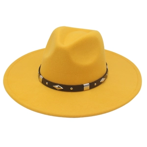 Detailed view of the yellow fedora hat with a black leather belt and silver diamond studs