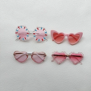 Pack of four pink stylish sunglasses for kids in heart and round wave shapes
