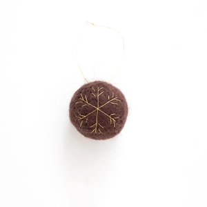 Brown plush Christmas ball with golden snowflake embroidery and hanging cord on white