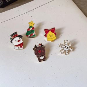Christmas enamel pins set featuring Santa, reindeer, and snowman on white background