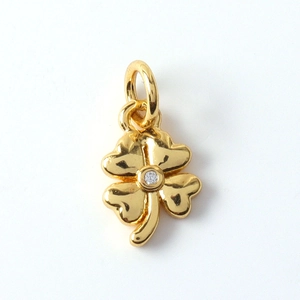 Detailed view of a gold-plated four-leaf clover pendant with a clear sparkling cubic zirconia