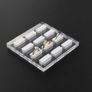 Detailed top view of clear acrylic ring display stand with multiple slots and white liners