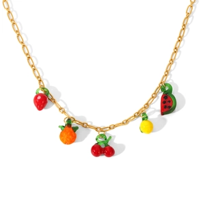 Close-up of golden necklace with five colorful fruit charms including strawberry and cherry