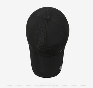 Close-up of black quilted baseball cap featuring diamond stitching and sport fashion label
