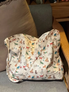 Minimalist canvas tote bag with colorful cartoon dog prints and wide shoulder strap