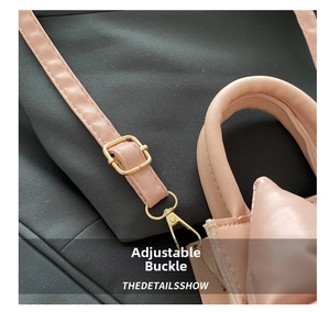 Close-up of pink leather handbag strap with adjustable shiny golden metal buckle