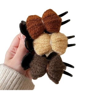 Three plush knitted bow hair clips in brown, beige and dark tan for autumn and winter hair styles