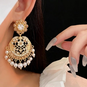 Vintage palace style gold hollow earrings with crystals and hanging white pearls