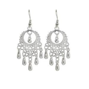 Detailed view of silver ethnic earrings featuring hollow leaf shapes and tassel drops