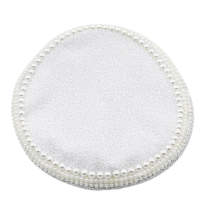 Detail of white bridal hat featuring shimmering sequins and layered pearl trim embroidery