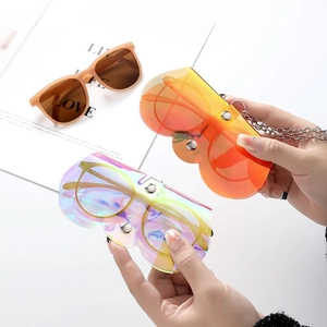 Vibrant orange laser PVC eyewear pouch and retro brown sunglasses with a modern gradient look