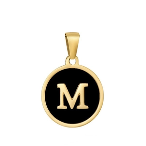 Macro detail of a gold letter M pendant with black enamel finish and metal border