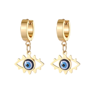 Detailed macro view of gold evil eye hoop earrings with blue enamel center finish