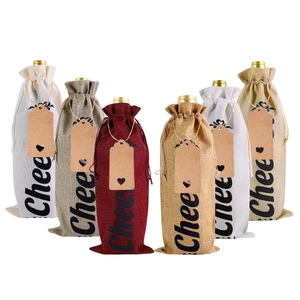 Linen Christmas wine bottle gift bags with Cheers print and heart tags on white background