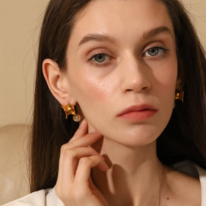 Chic 18K gold plated twisted earrings with white pearl drop on elegant female model