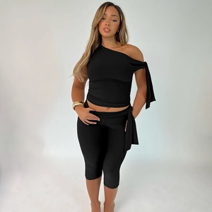 Women's two-piece set with black one-shoulder slim crop top and matching leggings