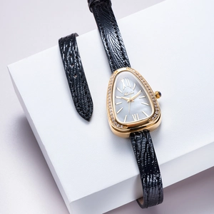 Detail of a luxury gold snakehead watch with triangle dial and black textured leather strap