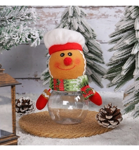 Macro view of Christmas candy jar with transparent globe and cute gingerbread man topper