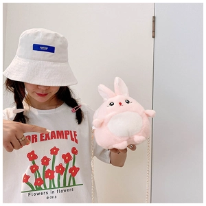Toddler girl modeling a pink plush bunny crossbody bag with a sleek gold chain strap