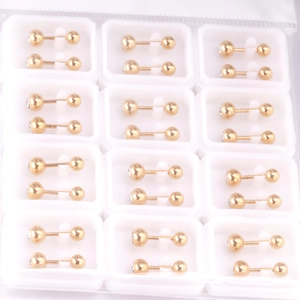 Detailed view of gold stainless steel barbell stud earrings in bulk display packaging
