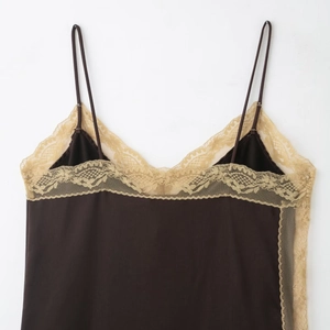 Sexy black satin camisole with beige lace trim and thin straps on a white background