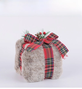 Detailed view of plush Christmas gift box with red green plaid bow and pine cone decoration
