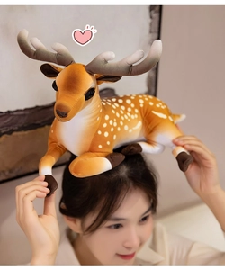 Detailed view of plush sika deer toy with soft spots and antlers being used as fun gift