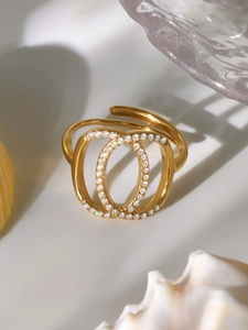 Macro shot of double oval interlocking gold ring with pavé cubic zirconia setting