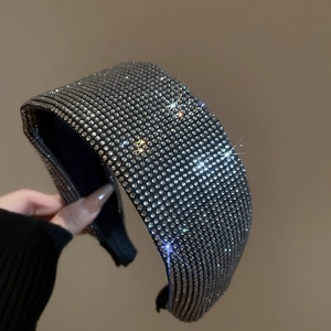 Macro detail of wide headband featuring densely inlaid sparkling silver rhinestones