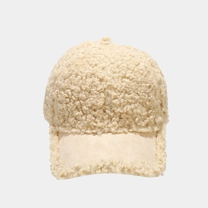 Close-up of warm cream sherpa baseball cap with a soft suede brim for winter wear