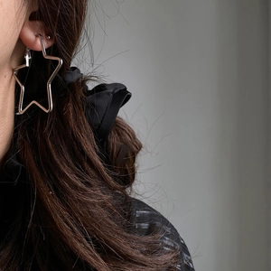 Minimalist silver star hoop earrings featuring a polished geometric design for women