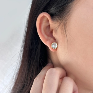 Detail of 10mm gold plated earring featuring a sparkling cubic zirconia stud on ear